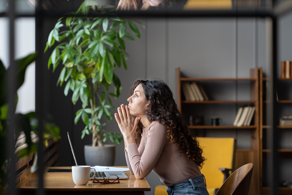 challenges facing women in tech image of woman at laptop looking sad